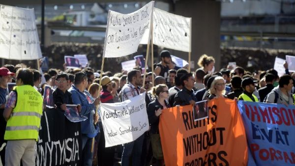 Supporters of Free Movement Group of Finland attend a demonstration at the Finnish Immigration Service headquarters in Helsinki, on September 8, 2016. The asylym seekers demonstrated against the tightened asylum policy of Finland. (AFP/Vesa Moilanen)