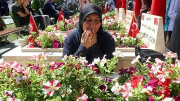 سيدة تركية تتلو الفاتحة امام قبر قريب لها قتل خلال المحاولة الانقلابية في تركيا قبل عامين بالتمام
