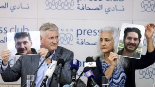 والدا الصحافي المخطوف في سوريا يرفعان صورا لابنهما خلال مؤتمر صحافي في بيروت
