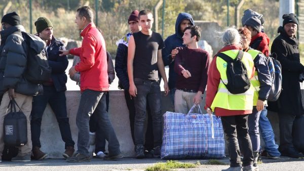 Young migrants wait to board a bus leaving for a reception center, in Calais, on October 28, 2016, following a massive operation to clear the "Jungle" migrant camp. (AFP/Philippe Huguen)