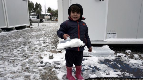A child plays in the snow at the Kara Tepe camp on the island of Lesbos following heavy snowfalls on January 7, 2017. (AFP/Stringer)