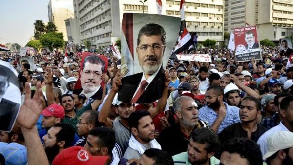 Pro-Muslim Brotherhood protesters hold banners in support of ousted Egyptian president Mohammed Mursi (AFP)