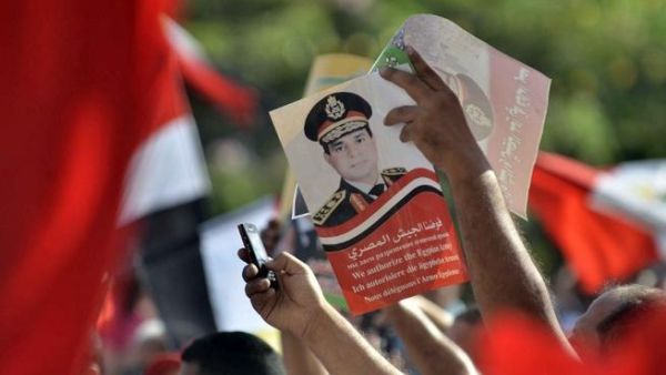 EGYPT, Cairo : Egyptian opponents of deposed president Mohamed Morsi hold up a poster of army chief General Abdel Fattah el-Sisi on July 26, 2013 during a protest in Cairo. AFP PHOTO/MOHAMED EL-SHAHED