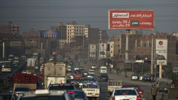 A billboard reading "participating in the constitution means YES for the 30th of June and the 25th of January" is seen on Cairo’s ring road on December 16, 2013. [AFP]