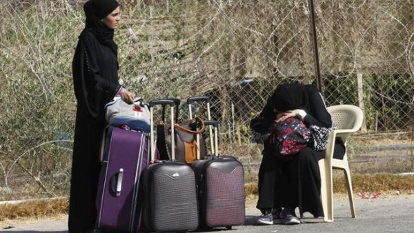 Palestinians wait near their luggage at the Rafah border terminal in the southern Gaza Strip before crossing into neighbouring Egypt on August 24, 2013. AFP PHOTO SAID KHATIB