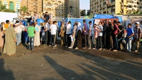 Egyptian supporters of Egypt's deposed president Mohamed Morsi queue to receive food just before breaking their fast during their ongoing sit-in protest outside Rabaa al-Adawiya mosque in Cairo on July 31, 2013.  (FAYEZ NURELDINE/AFP/Getty Images)