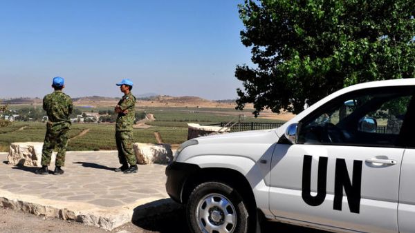 UN soldiers examine the Israeli-Syrian border on August (Shutterstock/ChameleonsEye)