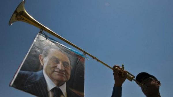 After one Mubarak fan hoisted his photo aloft a trumpet for May 11, the re-trial is once again postponed