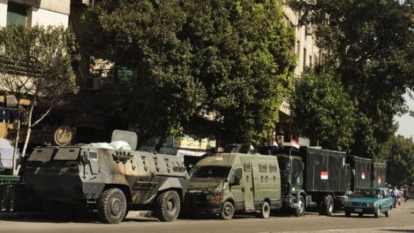 EGYPT, Cairo : Trucks and APC's of Egyptian riot police are parked in the main street leading to Egypt's landmark Tahrir square on August 20, 2013 in Cairo, Egypt.AFP PHOTO/GIANLUIGI GUERCIA