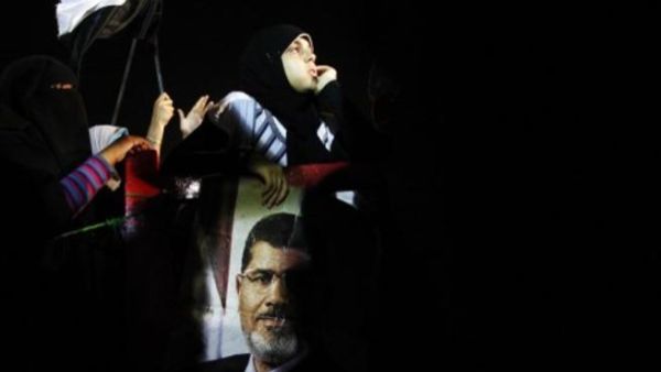 Protestor raises specter of deposed Morsi at Cairo rally turned violent, July 7 (Image Mahmoud Khaled / AFP)