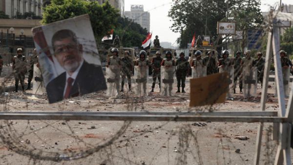 Soldiers of the Egyptian Army stand guard near the headquarters of the Egyptian Republican Guard one day after a shooting at the site of a pro-Morsi sit in (Image credit: Getty)