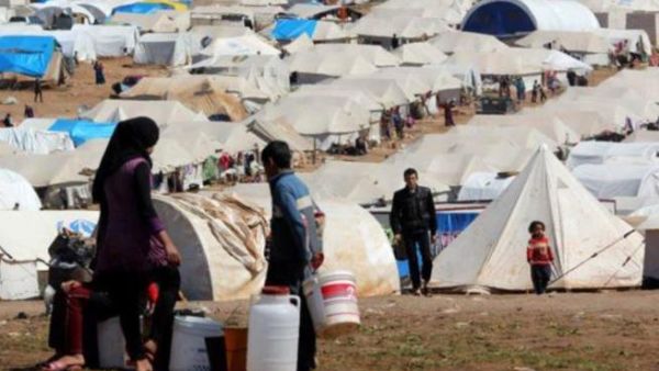 Syrian refugees filling their buckets at Atmeh refugee camp, in the northern Syrian province of Idlib, Syria, Apr. 5, 2013. [Getty Images]