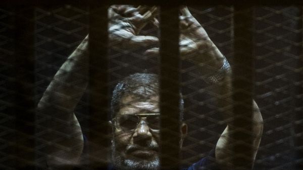 Mohamed Morsi is currently serving out three lengthy jail terms on charges of "killing protesters" and "spying for Qatar." (AFP/File)