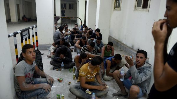 Survivors from a boat that capsized, off Egypt's north coast, sit in a police station in Rashid in northern Egypt, on September 21, 2016. (AFP/Mohammed El-Shahed)