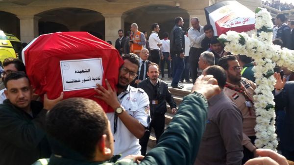 Egyptian mourners and officials carry the coffins of the victims of a bomb explosion that targeted a Coptic Orthodox Church the previous day in Cairo, at the end their funeral in the capital's Nasr City neighbourhood on December 12, 2016. (AFP/Khaled Desouki)