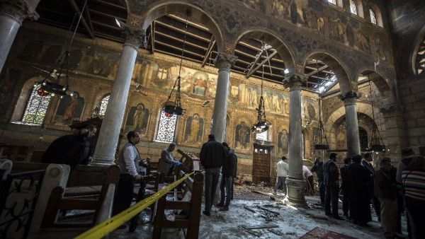 Egyptian security forces inspect the scene of a bomb explosion at the Saint Peter and Saint Paul Coptic Orthodox Church in Cairo on December 11, 2016. (AFP/Kaheld Desouki)
