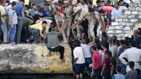 Egyptians stand on the shore as they wait for the recovery of bodies, during a search operation after a boat carrying migrants capsized in the Mediterranean, along the shore in the Egyptian port city of Rosetta on September 22, 2016. (Mohamed El-Shahed)