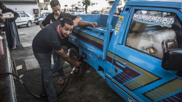 An Egyptian petrol station worker fills up a pickup truck's tank in the capital Cairo on June 29, 2017. Egypt announced a new sharp increase in fuel prices on June 29, 2017 as it slashed government subsidies in a tough IMF-backed reform program. (Khaled Desouki/AFP)