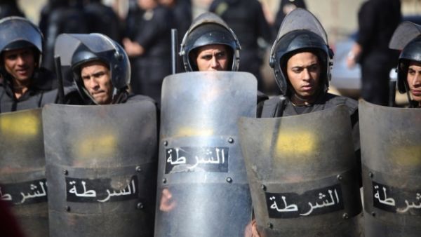 Egyptian police are seen in riot gear at a protest. (AFP)