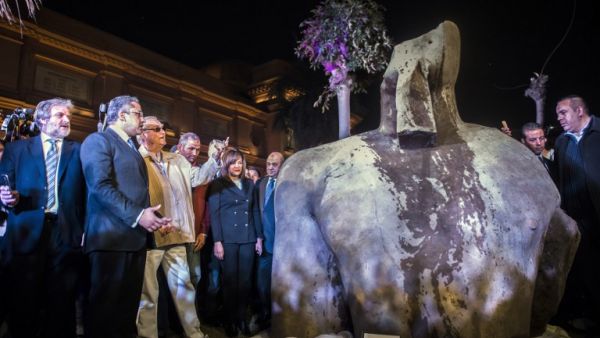 Egyptian Antiquities Minister Khaled el-Anani (2nd-L) and Denmark's Prince Henrik (3rd-L), look at the torso part of a statue believed to depict King Psamtek I, outside the Egyptian Museum in Cairo on March 16, 2017. (AFP/Khaled Desouki)