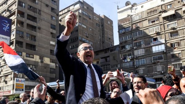 Egyptian lawyer and former presidential candidate Khaled Ali celebrates the decision amid street crowds (Mohamed El-Shahed/AFP)