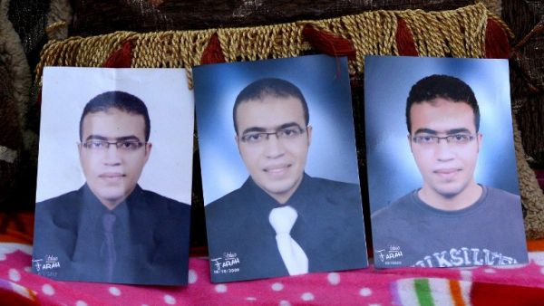 A picture taken on February 5, 2017, shows portraits of Abdallah El-Hamahmy, an Egyptian suspected of being the machete attacker in Paris's Louvre museum, placed on a sofa at the family home in the Nile delta city of Mansura, some 120 kms north of Cairo. (AFP/Mahmood Shahin)