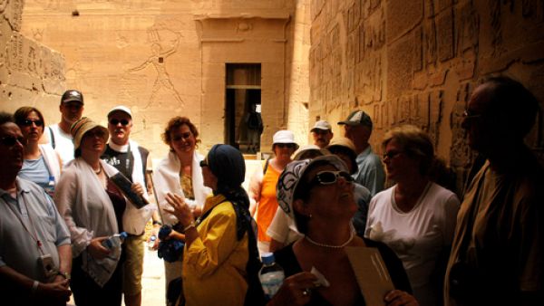 Visitors with a tour guide at the Temple of Philae near Aswan. (Shutterstock/ChameleonsEye)