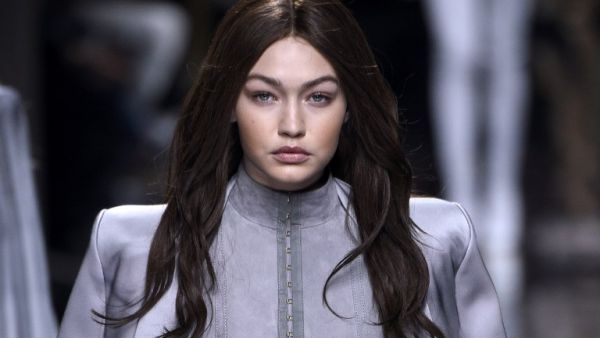 Gigi maintained her brunette locks while stepping out in Paris with Kendall after the show. (AFP/Martin Bureau)