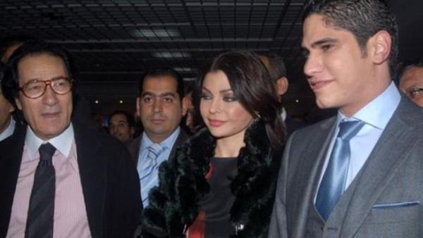 Haifa flanked by men, including husband Abu Hashima (R)