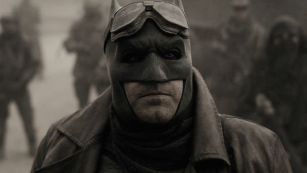 "Tell me. Do you bleed?" says Batman, whipping-out his sax. He places his lips on the mouthpiece. "You will." (Warner Bros. Entertainment, Inc.)