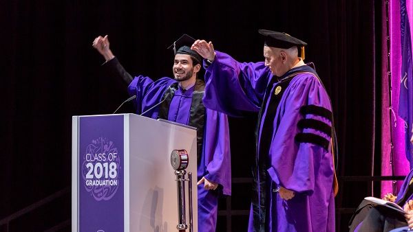 Fouad Hassan, the student speaker at NU-Q’s graduation ceremony, and Dean Everette E. Dennis perform the Northwestern Wildcat cheer. Fouad Hassan, the student speaker at NU-Q’s graduation ceremony, and Dean Everette E. Dennis perform the Northwestern Wildcat cheer.