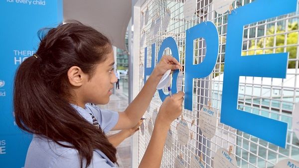 A GEMS student writes her message of hope for children around the world. A GEMS student writes her message of hope for children around the world.