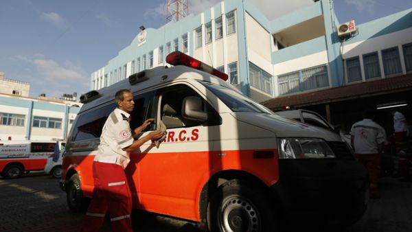 A Palestinian Red Crescent worker washes his ambulance after carrying wounded in Beit Lahia in the northern Gaza Strip. (AFP/ File)