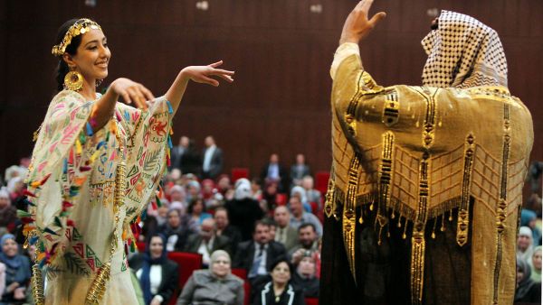 Iraqi dancers in folkloric dress perform at a festival in Baghdad celebrating International Women's Day.  (AFP/Ahmad al-Rubaye)
