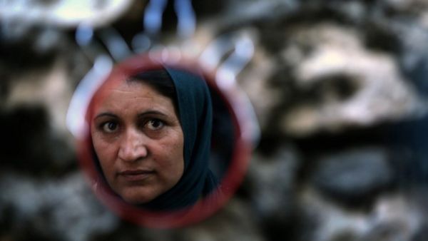 A mirror shows the reflection of an Iraqi woman.  (AFP/File)