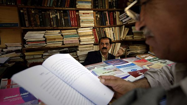A customer browses books in a shop on Mutanabi Street, famed as Baghdad's bookselling district.  A scarcity of science literature available in Iraq inspired the Real Sciences group to translate works into Arabic.  (AFP/Joseph Eid)