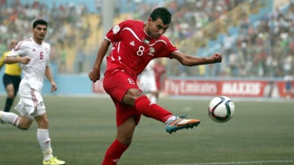 Sameh Maraaba, Palestinian forward, kicks the ball during the Palestinian national team's 2018 FIFA World Cup qualifying match against the UAE on September 8, 2015 in the West Bank.  (AFP/Thomas Coex)