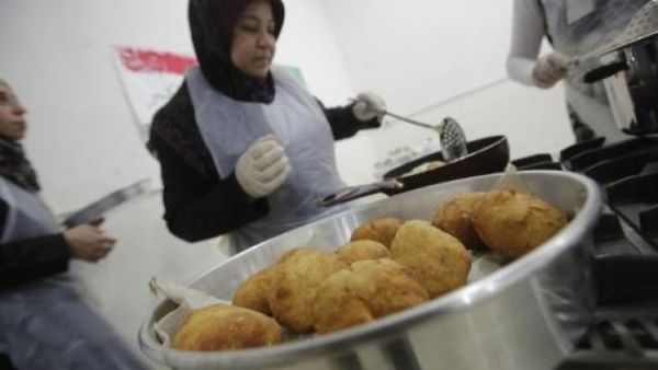 Syrian refugee women prepare traditional dishes in Beirut, Lebanon.  (AFP/Joseph Eid)