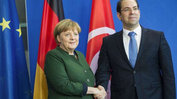 German Chancellor Angela Merkel and Tunisian Prime Minister Youssef Chahed shake hands after a press conference at the Chancellery in Berlin on February 14, 2017. (AFP/File)