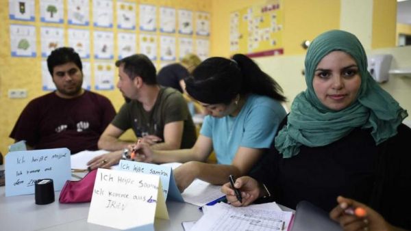 Refugees attend a German course in a classroom at a temporary home providing assistance for refugees in Berlin's Gatow district. (AFP/ TOBIAS SCHWARZ)