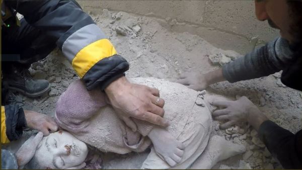 The body of a Syrian child is pulled out from the rubble following an airstrike in Eastern Ghouta, Syrian Civil Defense - Rif Dimushq