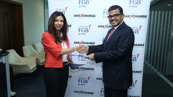 Hana Rostamani, Head of Consumer Banking, FGB and Promoth Manghat, CEO, UAE Exchange exchanging signed agreement Hana Rostamani, Head of Consumer Banking, FGB and Promoth Manghat, CEO, UAE Exchange exchanging signed agreement