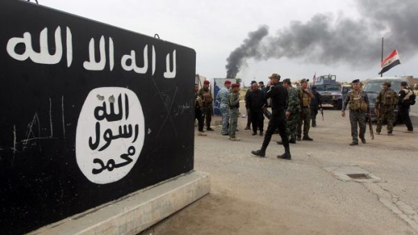 Bullet holes shown in an ISIS logo, AFP/File