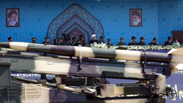 An Iranian medium range missile Zelzal passes by Iranian President Hassan Rouhani during an annual military parade. (str/afp)