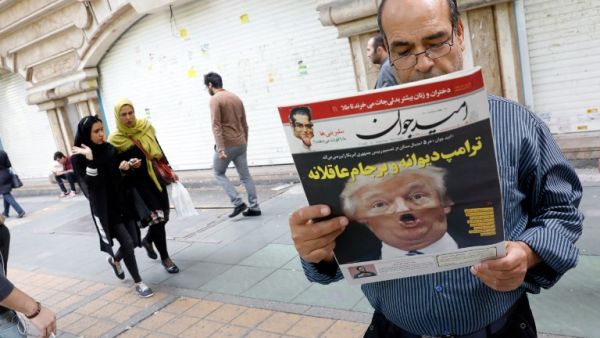 An Iranian man reads a copy of the daily newspaper 'Omid Javan' bearing a picture of U.S. President Donald Trump with a headline that reads in Persian "Crazy Trump and logical JCPOA (Joint Comprehensive Plan of Action)" (AFP)
 An Iranian man reads a copy of the daily newspaper 'Omid Javan' bearing a picture of U.S. President Donald Trump with a headline that reads in Persian "Crazy Trump and logical JCPOA (Joint Comprehensive Plan of Action)" (AFP)