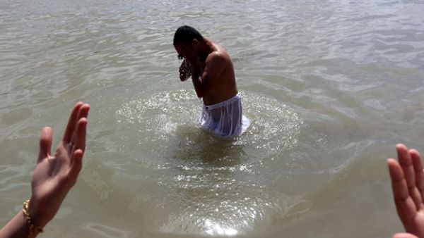 Iraqis Sabeans, followers of a pre-Christian religion which considers the prophet Abraham as one of the founders of their faith, stands in the water as he prays to mark Eid Al-Khalqeh (creation of the world) on the banks of the Tigris River in Baghdad. (AFP/File)