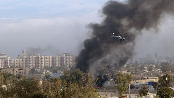 A Blackwater helicopter circles the site of a car bombing in Baghdad, 2004 (Wikimedia Commons)