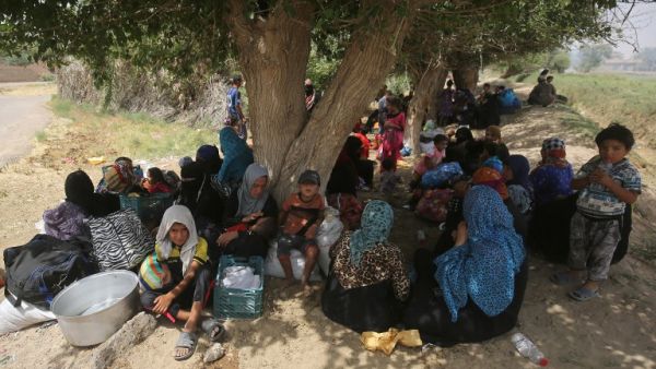Displaced Iraqi civilians wait to receive assistance after fleeing Fallujah. (AFP/File)