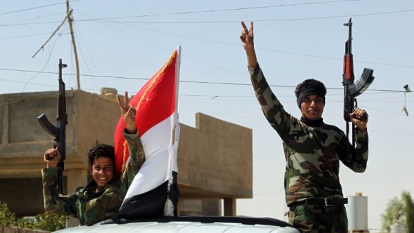 Iraqi government forces celebrate in the town of Sharqat, around 50 miles south of the city of Mosul, on September 23, 2016. (AFP/Ahmad al-Rubaye)