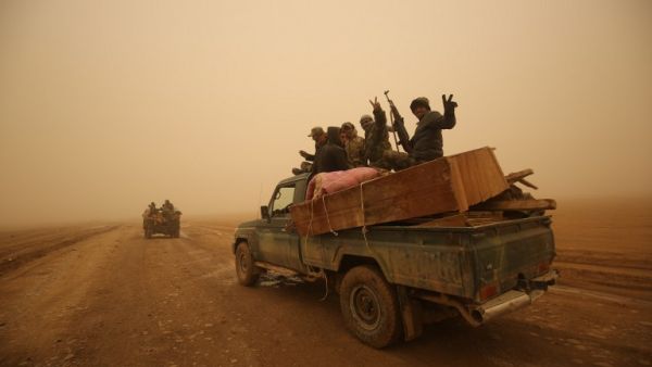 Shia fighters from the Hashed al-Shaabi (Popular Mobilization) paramilitaries drive through a desert area near the village of Al-Boutha al-Sharqiyah, west of Mosul, on December 2, 2016. (AFP/Ahmad al-Rubaye)